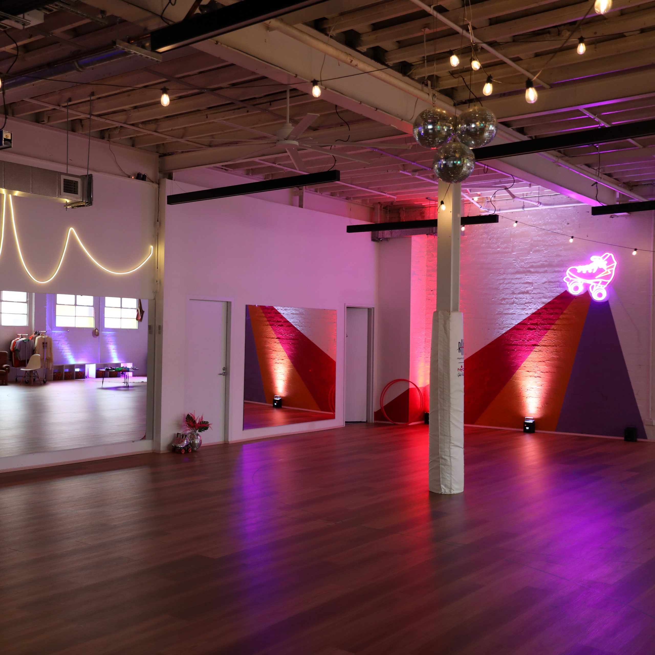 Venue Hire 1 RollerMart studio in Sydney lit up with party lighting and disco balls ready for venue hire.